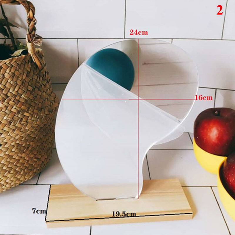 Irregular bean-shaped mirror on wooden base